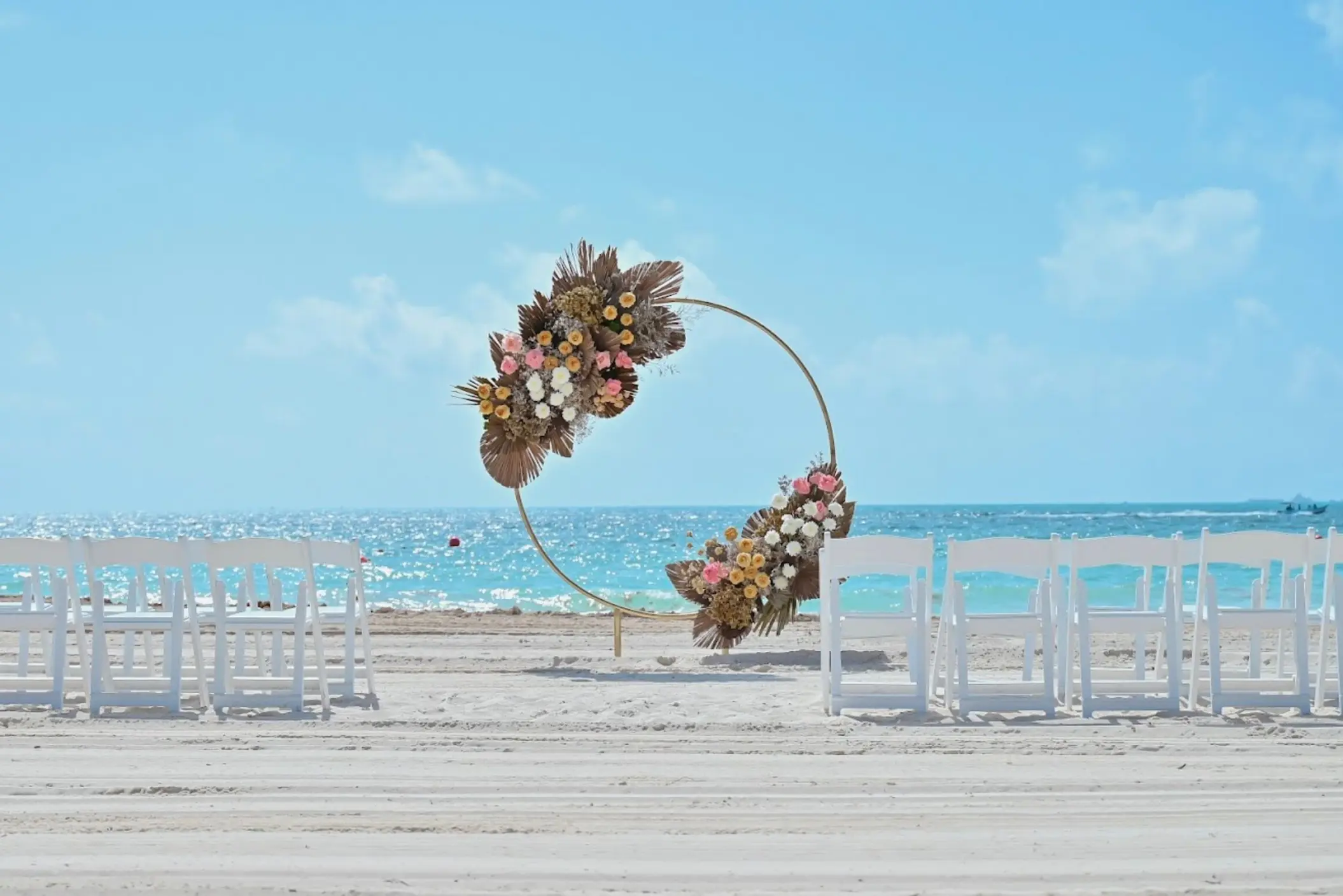 Circular floral wedding arch on the beach at Catalonia Grand Costa Mujeres, Cancun