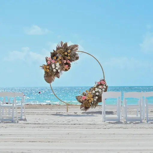 Circular floral wedding arch on the beach at Catalonia Grand Costa Mujeres, Cancun