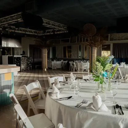 Indoor wedding reception venue with round dining tables and a dance floor at Catalonia Grand Costa Mujeres, Cancun