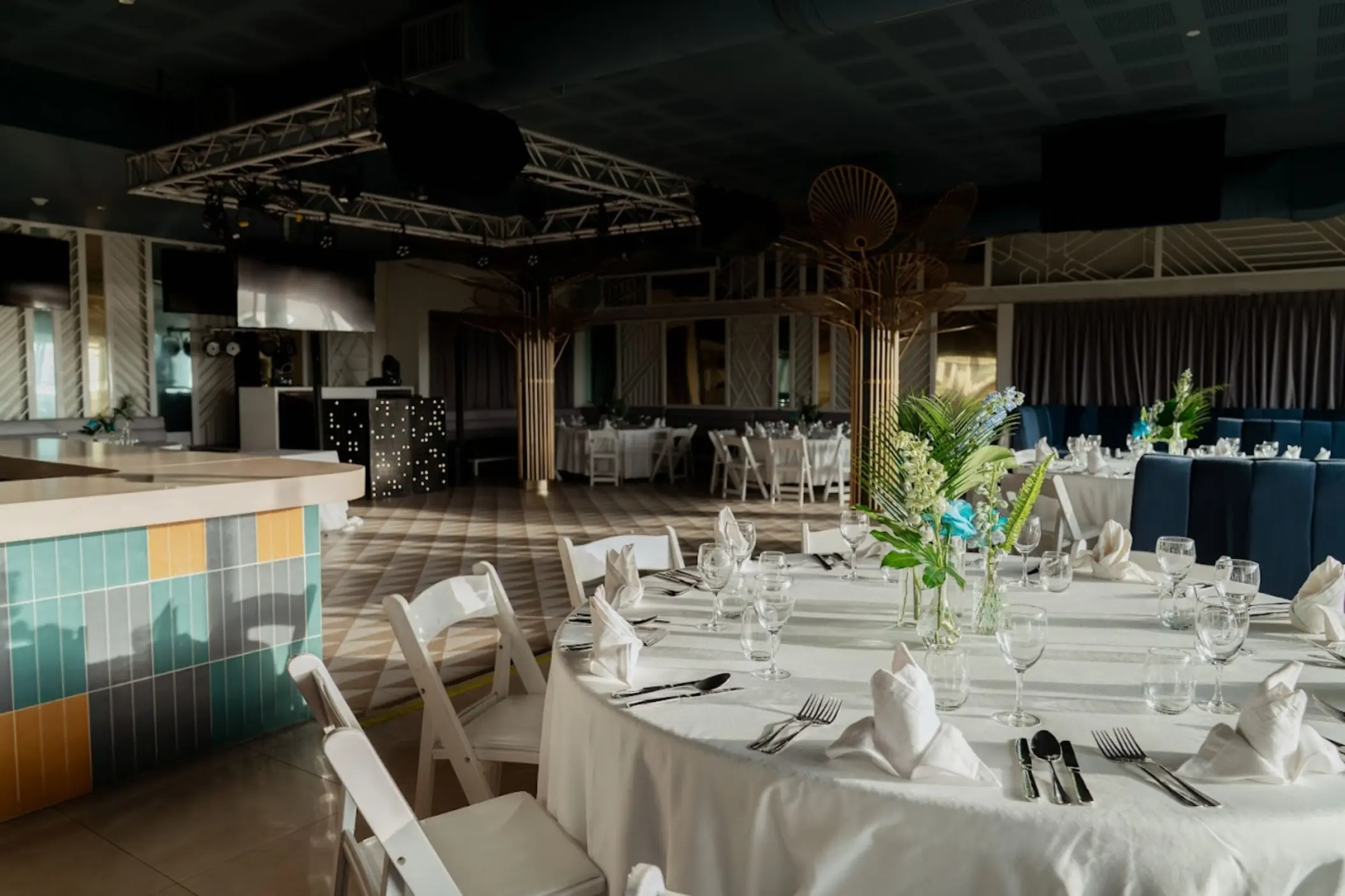Indoor wedding reception venue with round dining tables and a dance floor at Catalonia Grand Costa Mujeres, Cancun