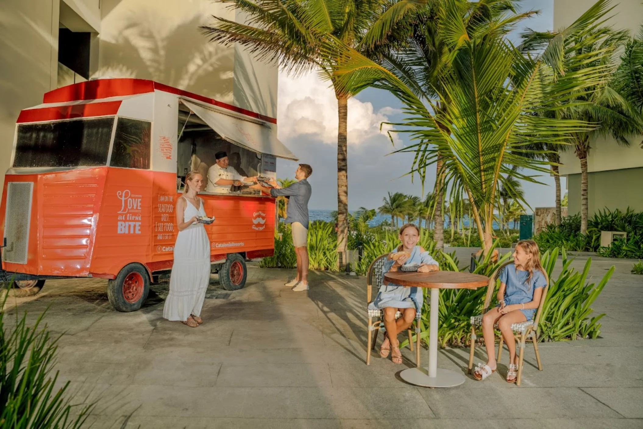 a family enjoying food at the food truck at Catalonia Grand Costa Mujeres