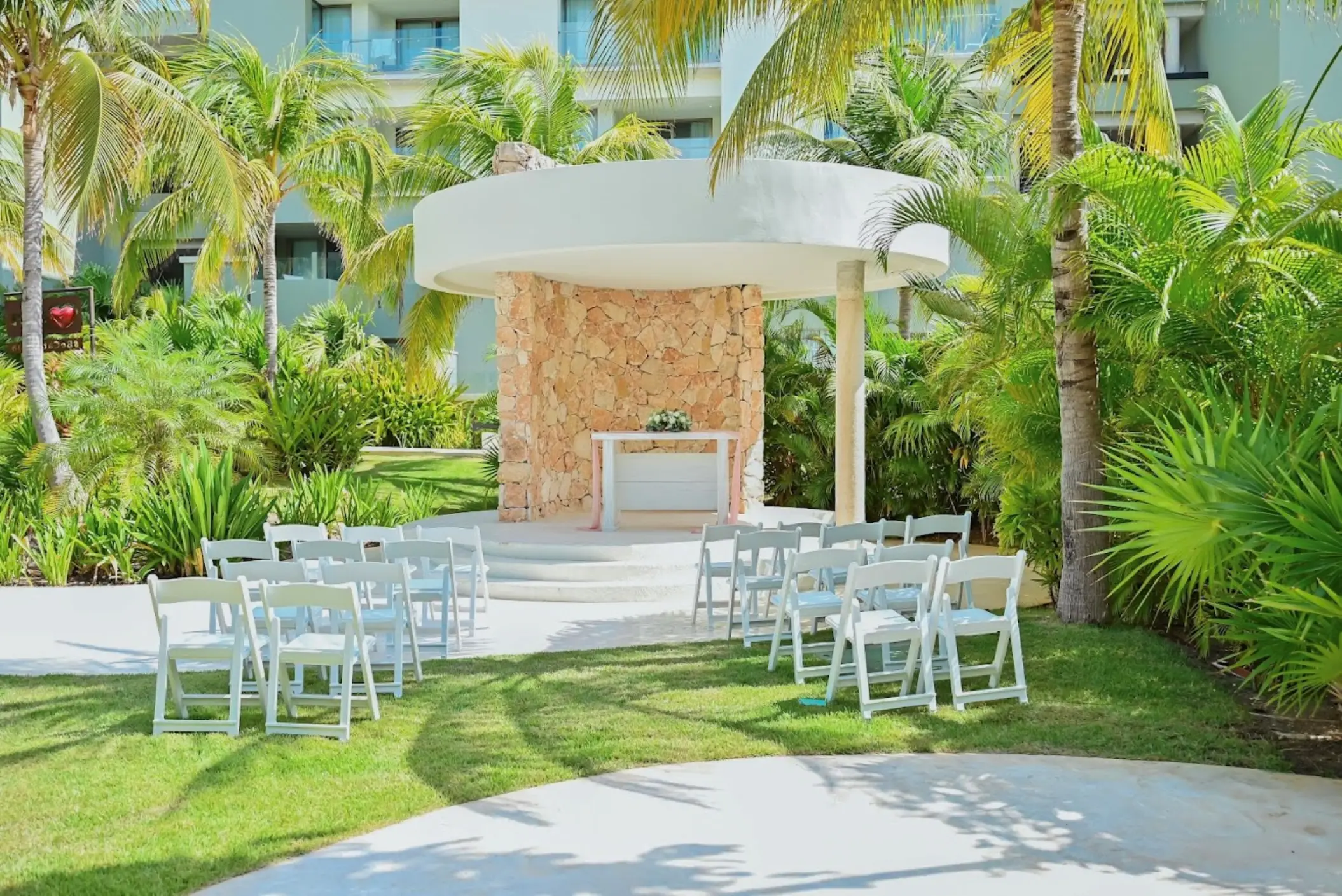Garden gazebo wedding ceremony with white chairs at Catalonia Grand Costa Mujeres, Cancun