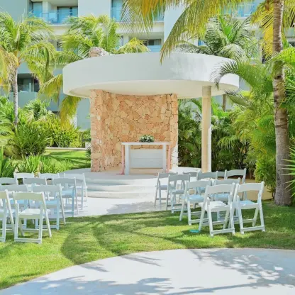 Garden gazebo wedding ceremony with white chairs at Catalonia Grand Costa Mujeres, Cancun