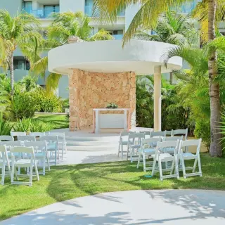 Garden gazebo wedding ceremony with white chairs at Catalonia Grand Costa Mujeres, Cancun