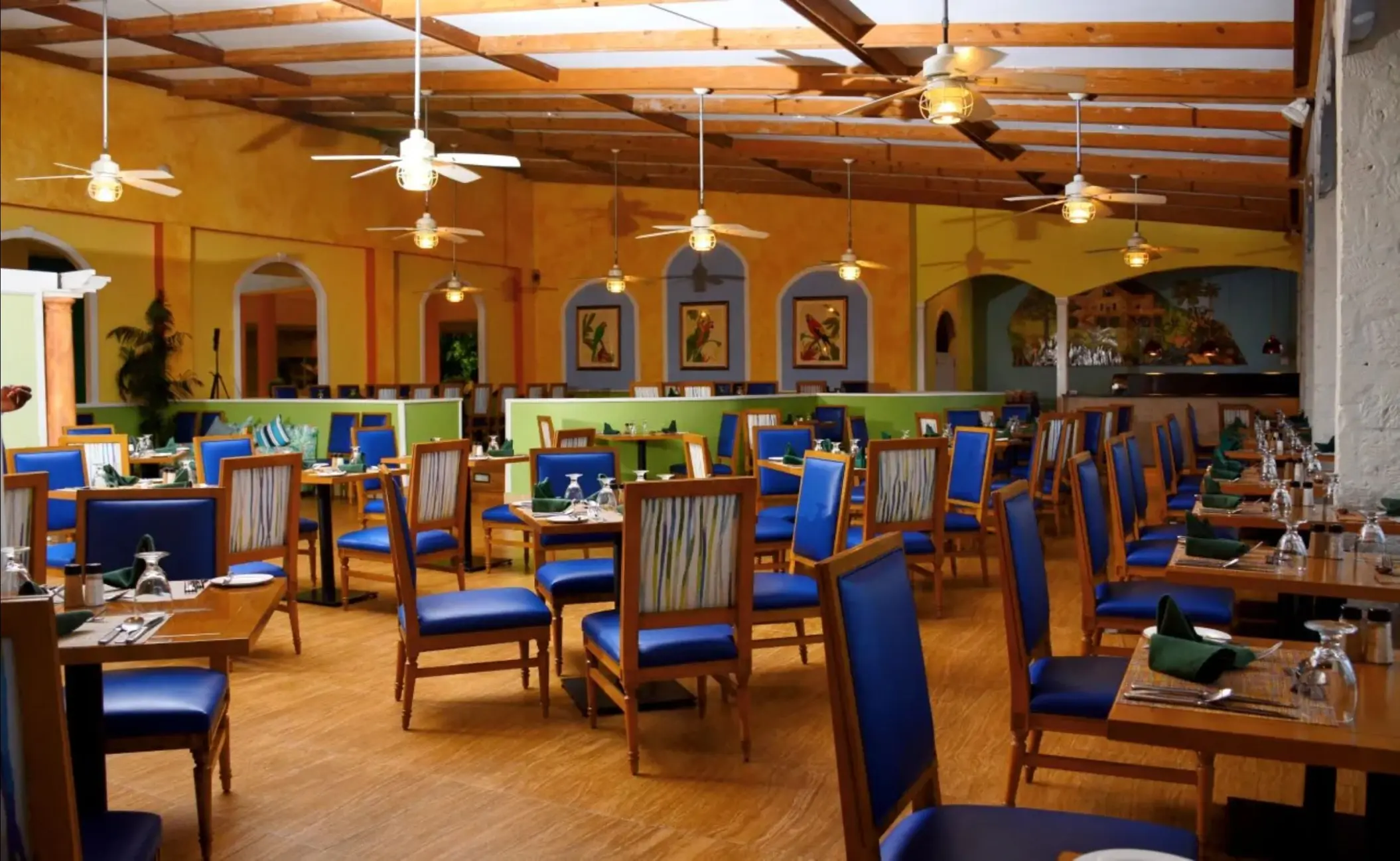 Bloved restaurant interior with blue chairs and wooden tables at Catalonia Montego Bay