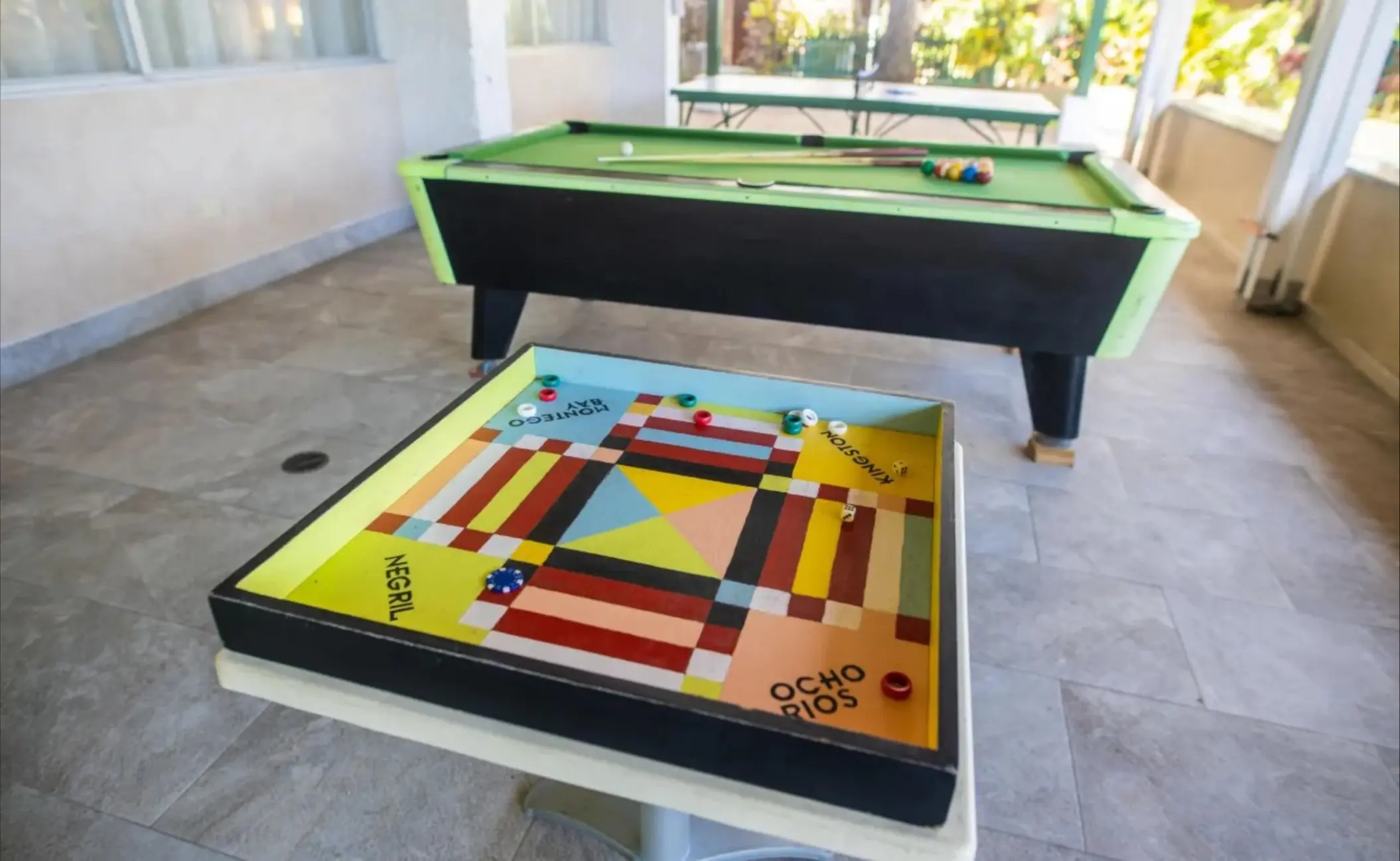 Outdoor play zone with a pool table and board games at Catalonia Montego Bay