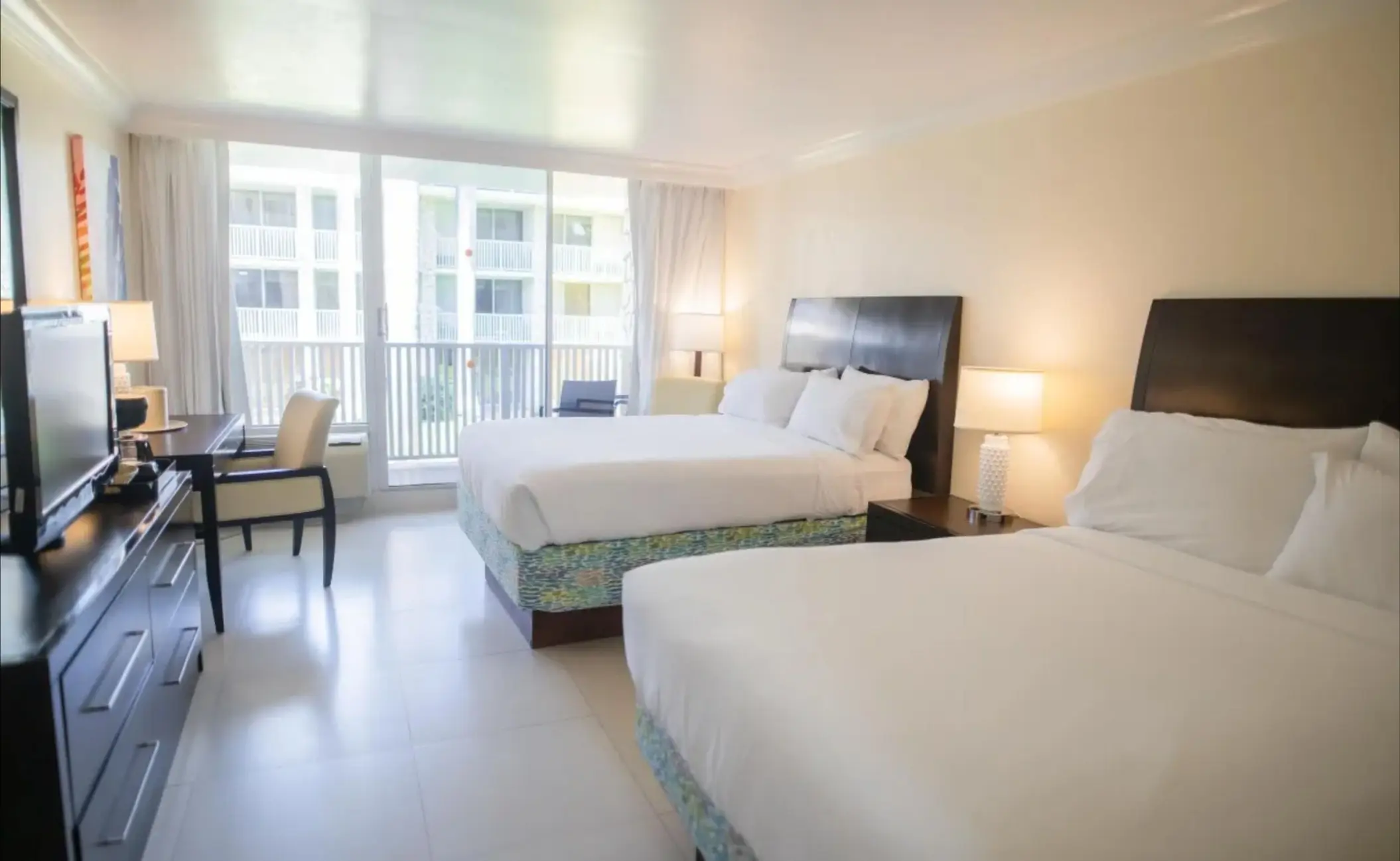 Guest room with two double beds and a private balcony at Catalonia Montego Bay