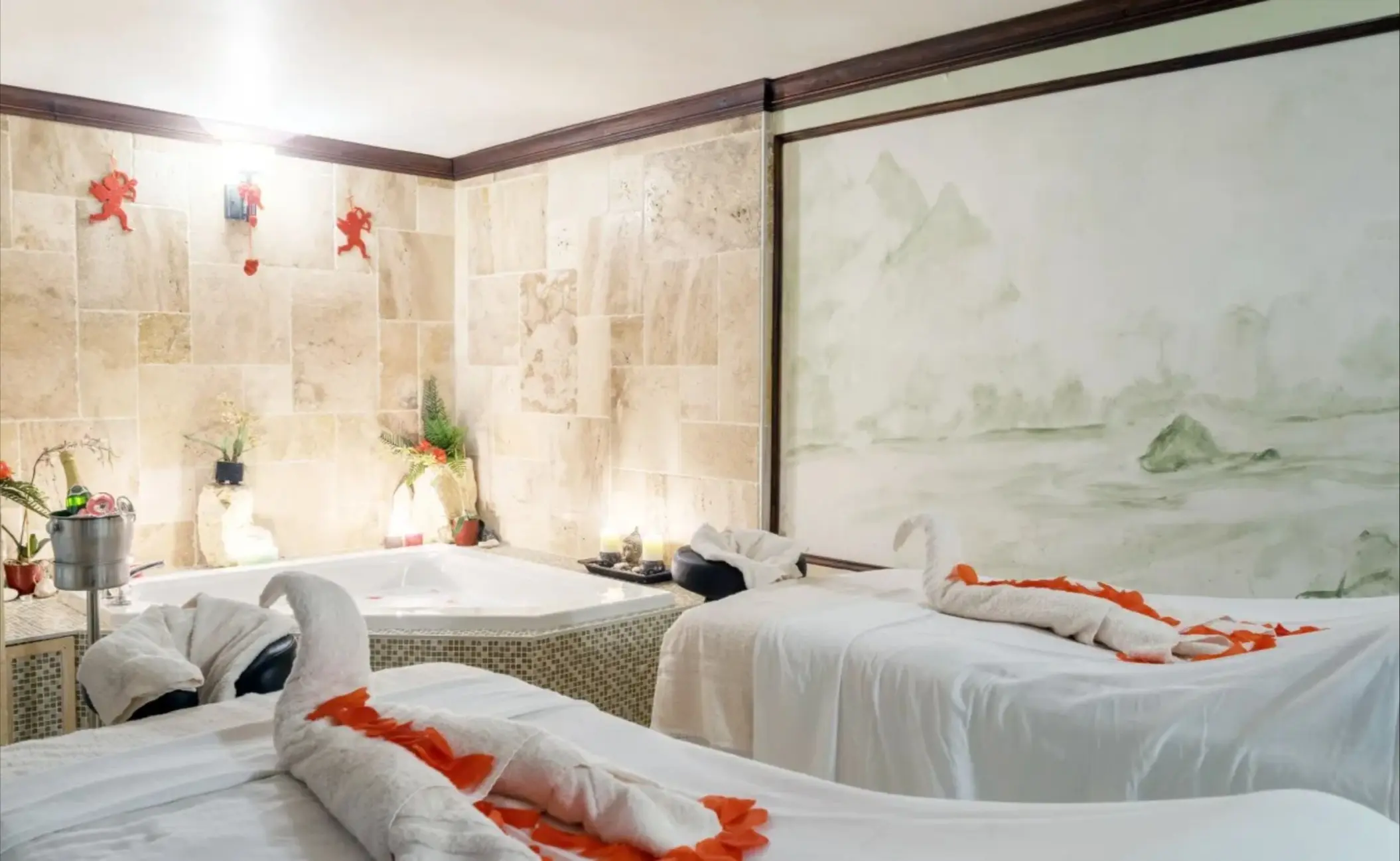 Couples massage room with swan towels and a whirlpool tub at Catalonia Montego Bay