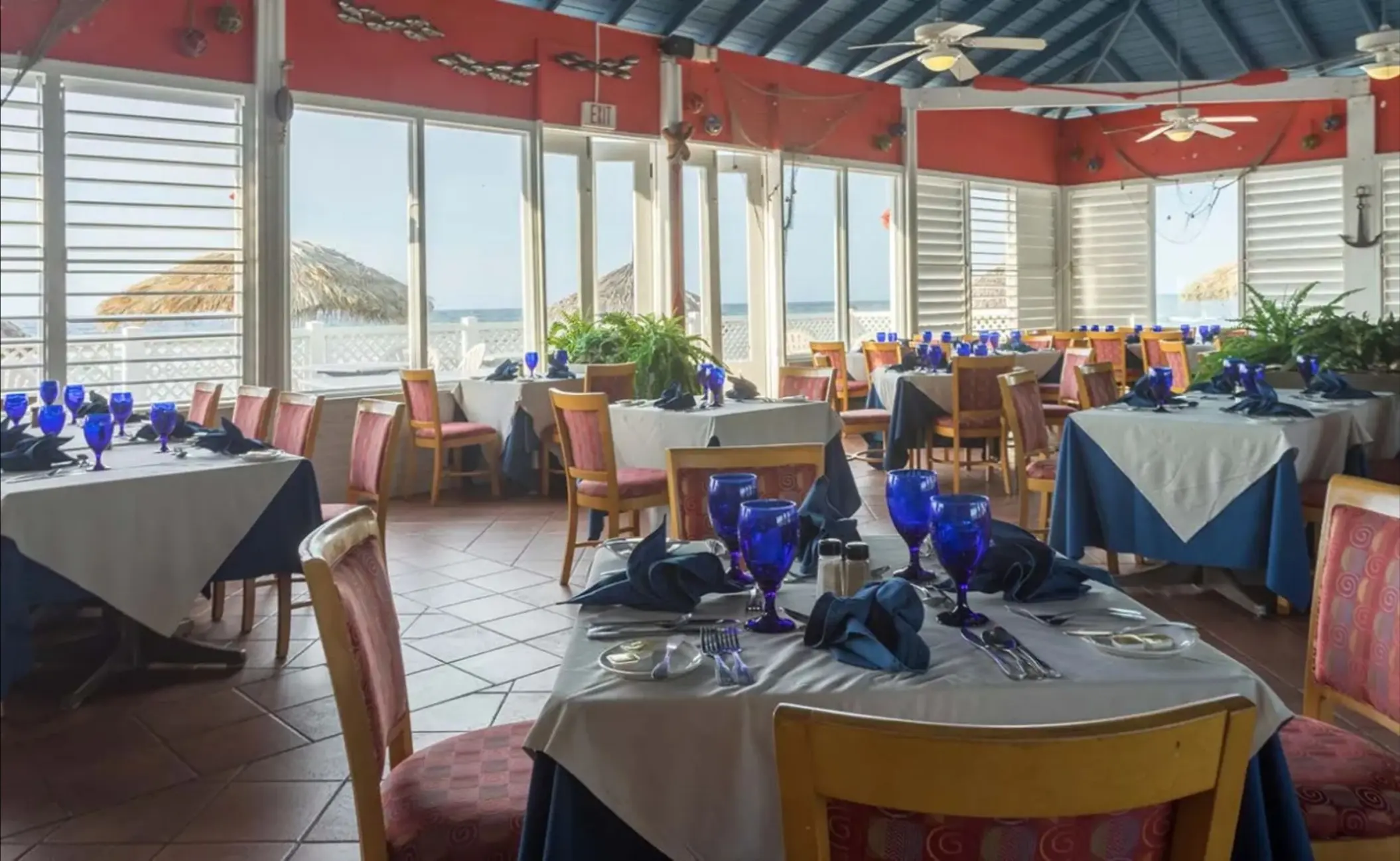 Terrace restaurant with blue glassware and ocean views at Catalonia Montego Bay, Montego Bay
