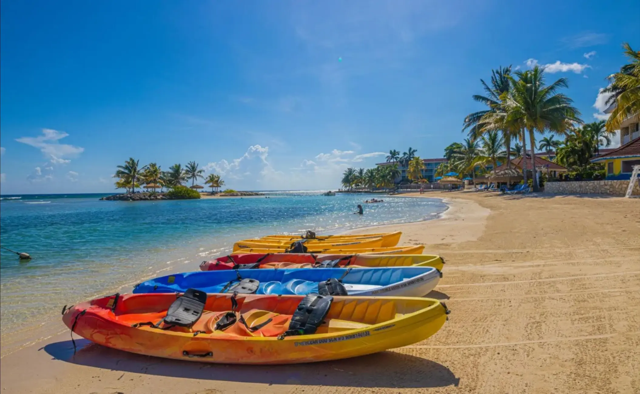 Colorful kayaks on the sandy beach at Catalonia Montego Bay, Montego Bay