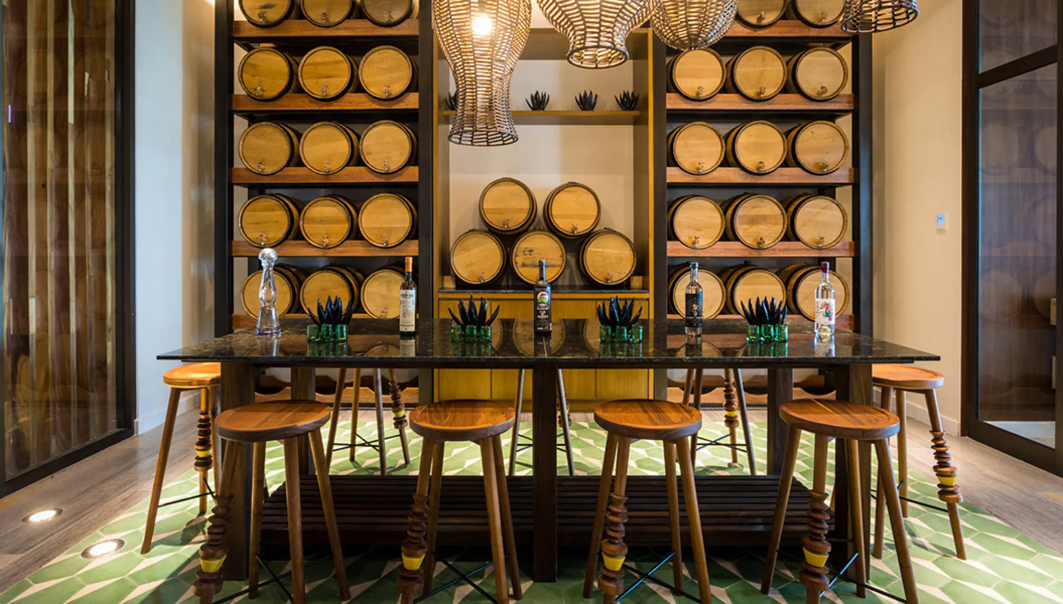 Agave Studio tasting room with wooden barrels and bar seating at Conrad Punta de Mita, Puerto Vallarta