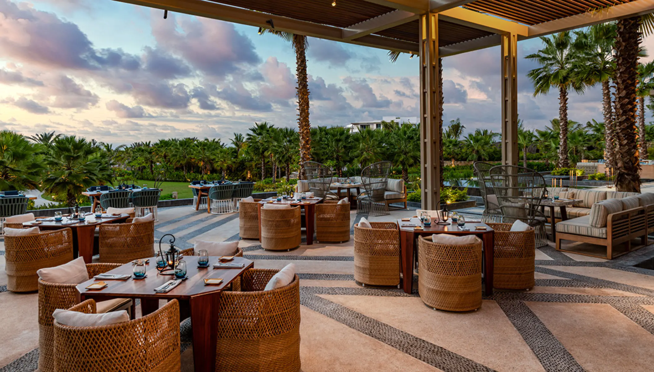 Arbol Terrace restaurant with wicker seating and outdoor tables at Conrad Punta de Mita, Puerto Vallarta