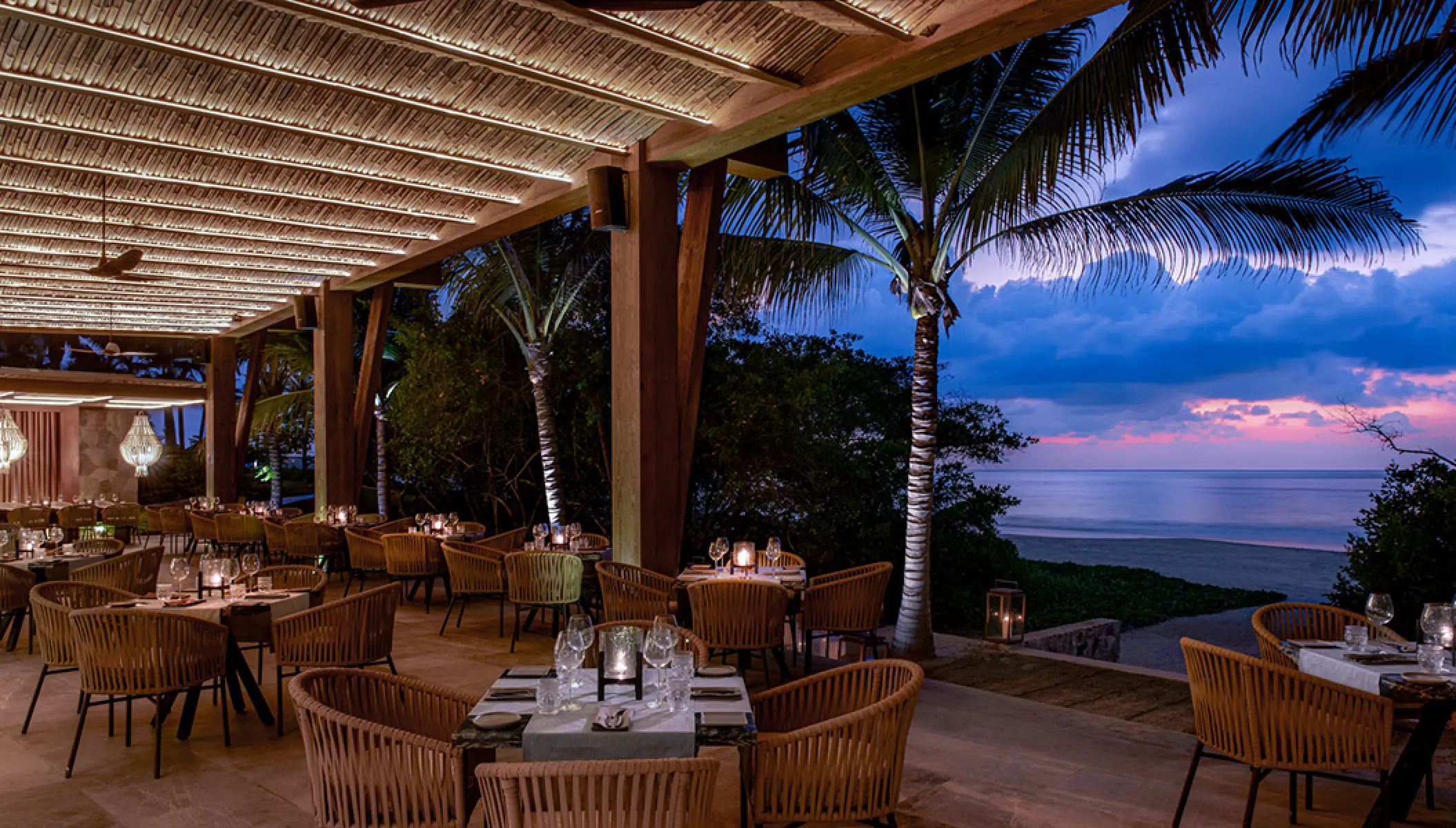 Open-air restaurant dining area at Conrad Punta de Mita overlooking the ocean at sunset, Puerto Vallarta