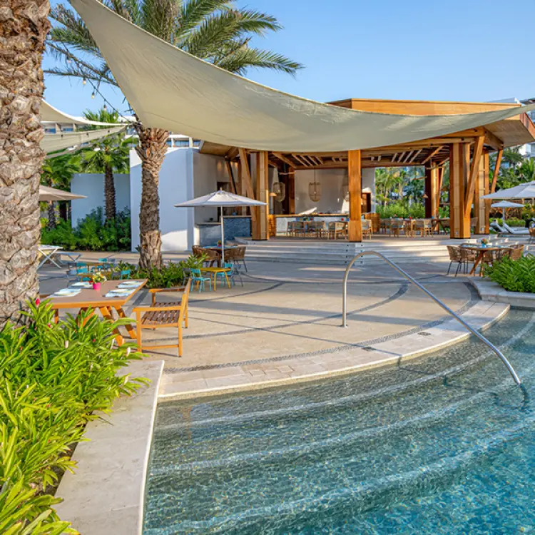 Outdoor Paleta pool bar and shaded dining terrace at Conrad Punta de Mita, Puerto Vallarta