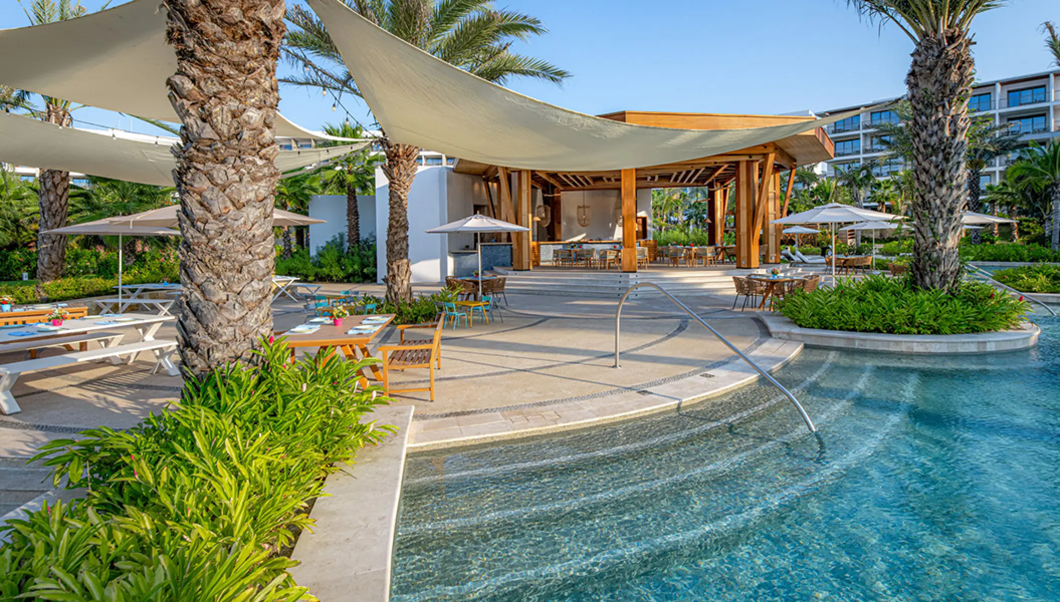 Outdoor Paleta pool bar and shaded dining terrace at Conrad Punta de Mita, Puerto Vallarta