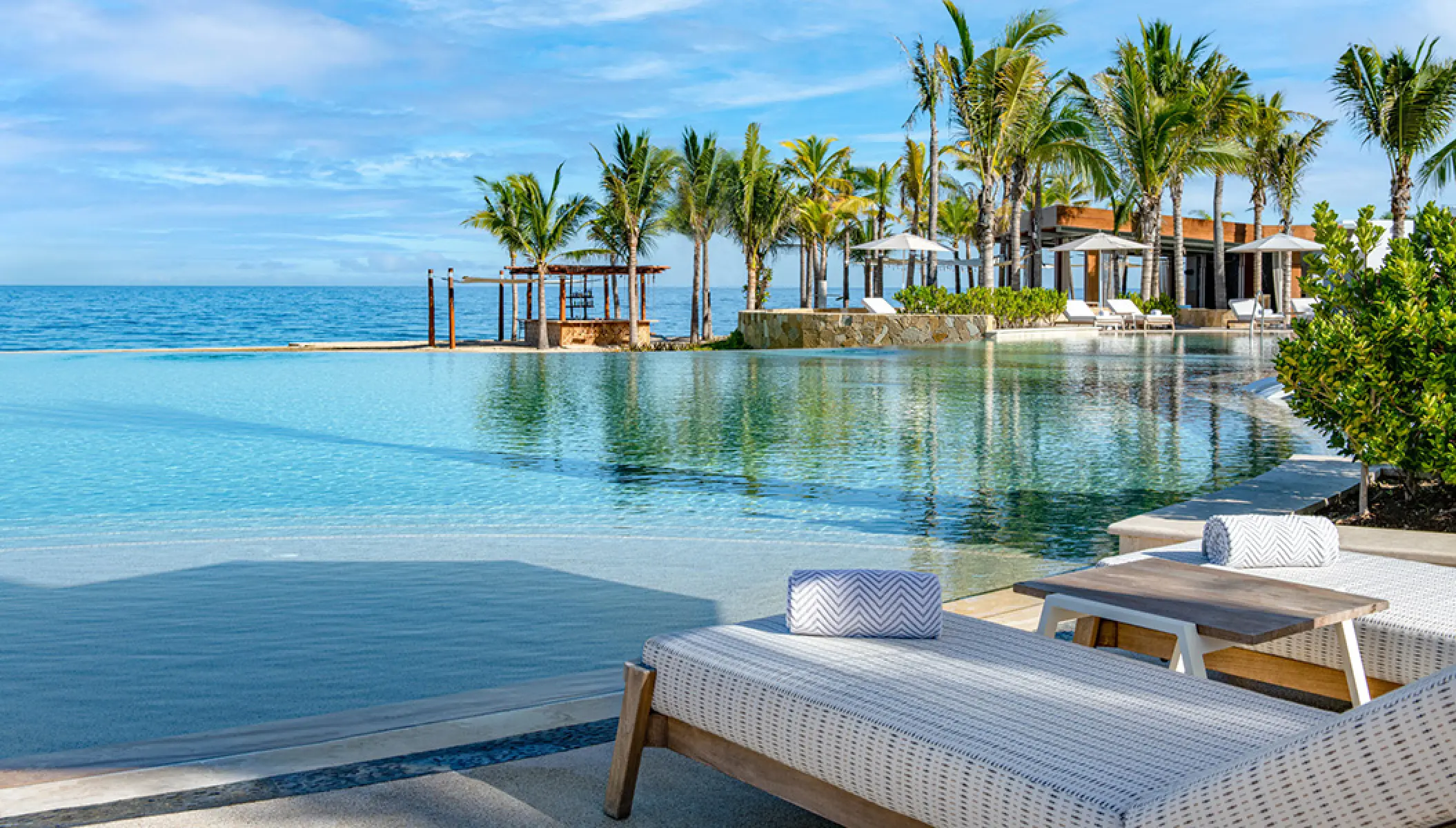 Conrad Punta de Mita infinity pool with lounge chairs and palm trees, Puerto Vallarta