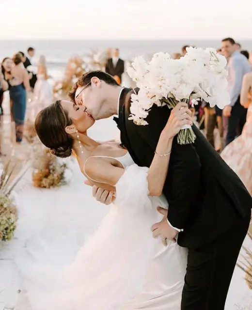 Bride and groom kissing at their beach ceremony at Conrad Punta de Mita, Puerto Vallarta