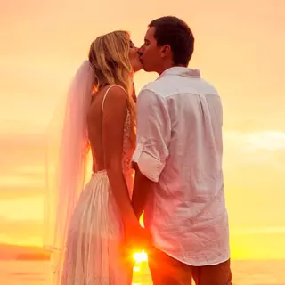 Bride and groom kissing at sunset at Conrad Punta de Mita, Puerto Vallarta