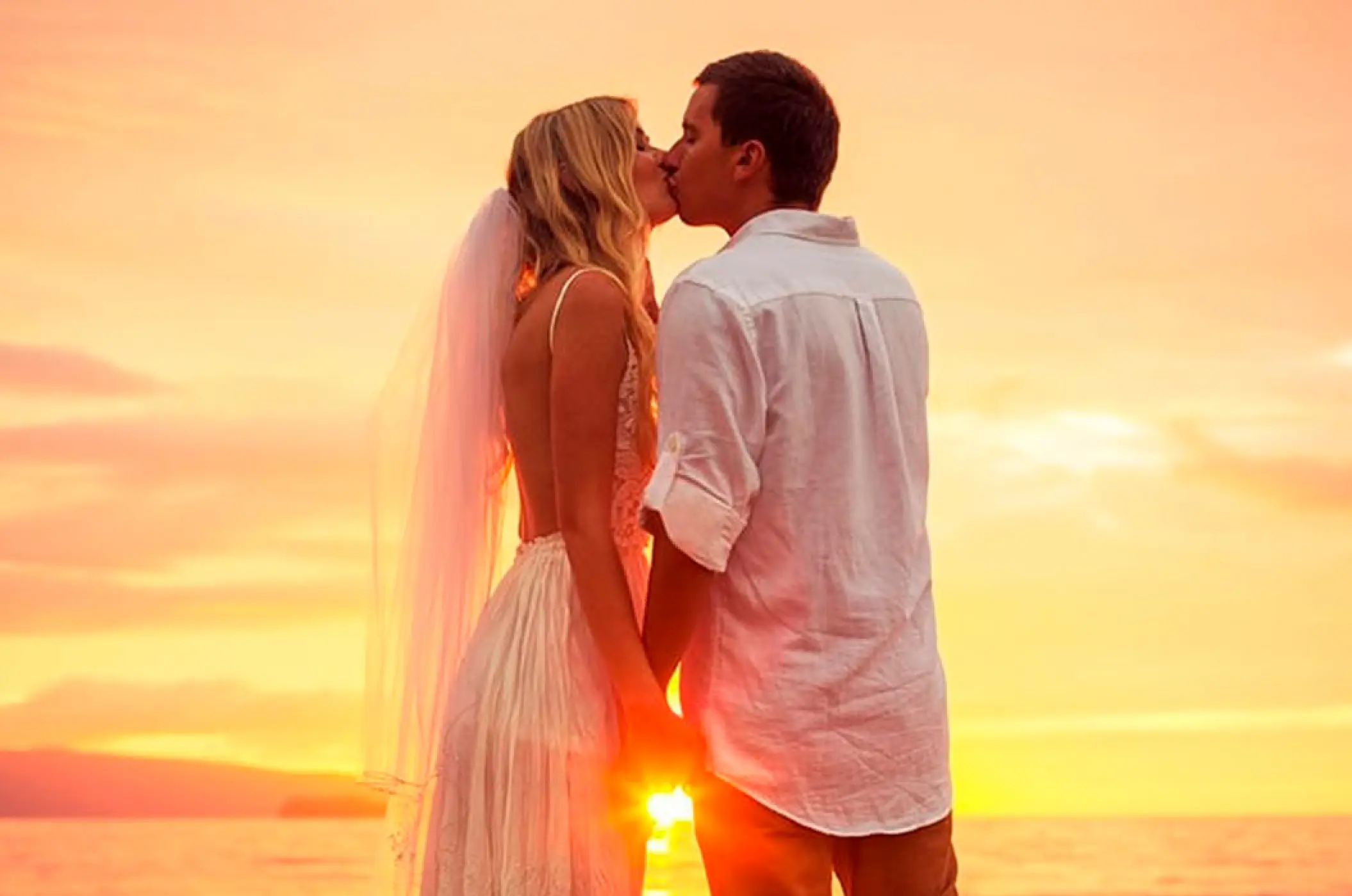 Bride and groom kissing at sunset at Conrad Punta de Mita, Puerto Vallarta