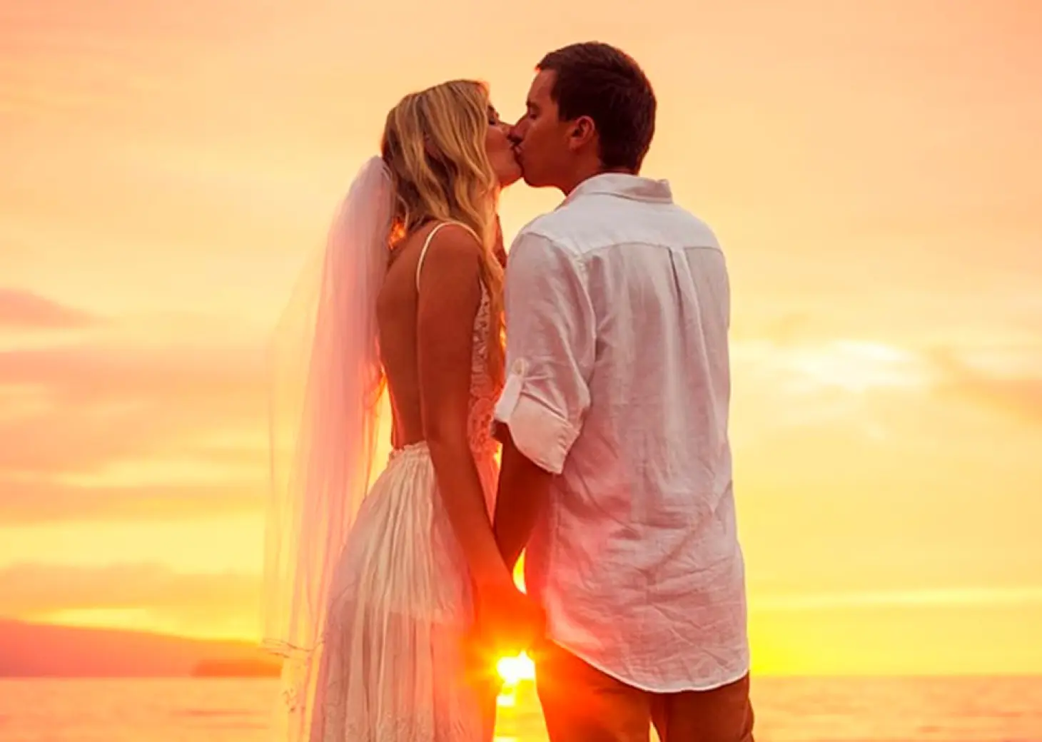 Bride and groom kissing at sunset at Conrad Punta de Mita, Puerto Vallarta