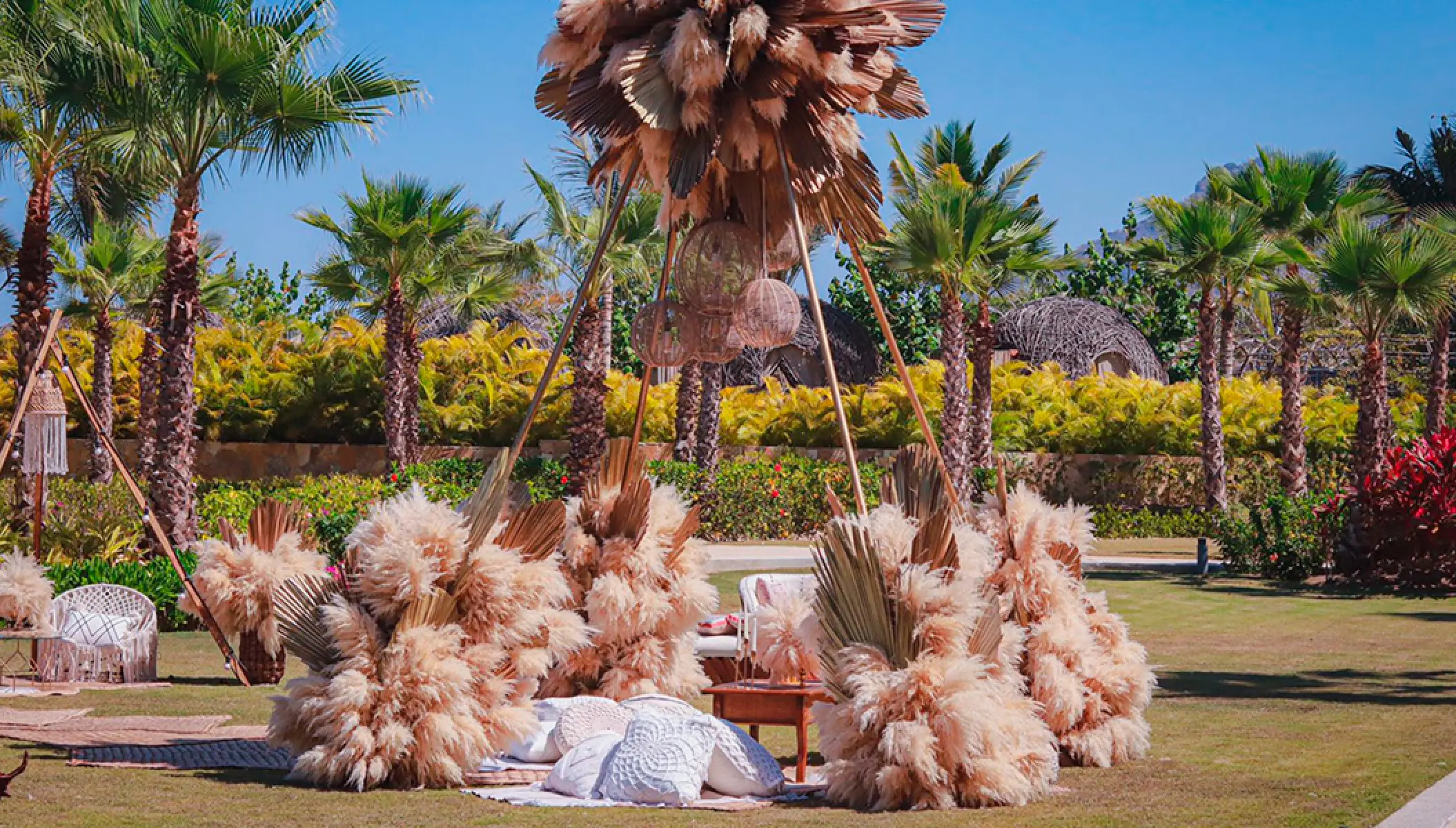 Outdoor wedding lounge with pampas grass and palm leaves at Conrad Punta de Mita, Puerto Vallarta