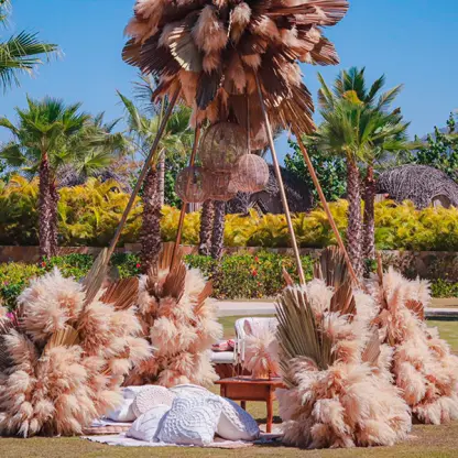 Outdoor wedding lounge with pampas grass and palm leaves at Conrad Punta de Mita, Puerto Vallarta