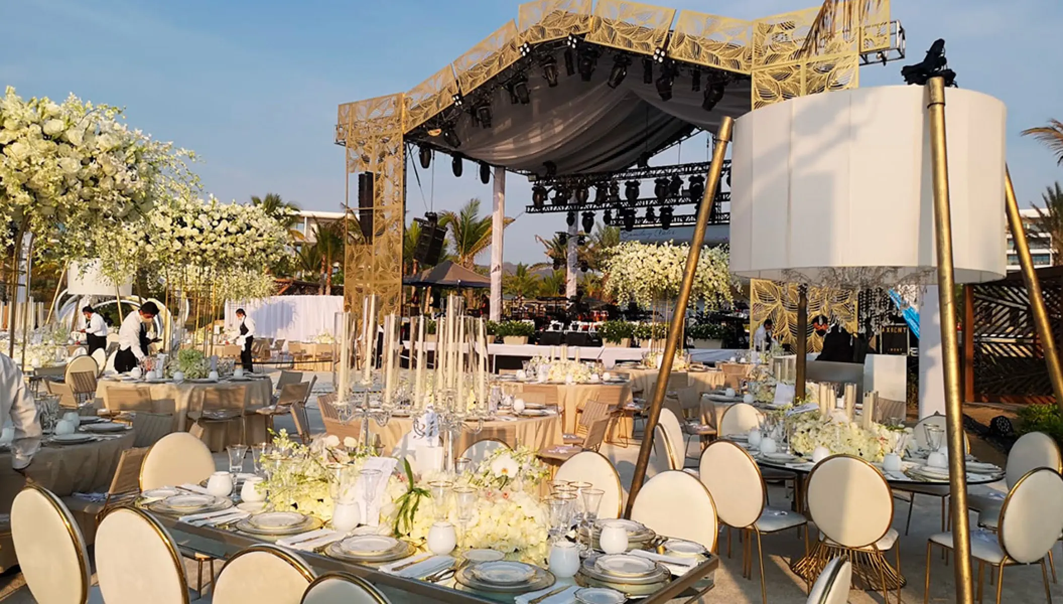 Outdoor wedding reception setup with white floral centerpieces at Conrad Punta de Mita, Puerto Vallarta