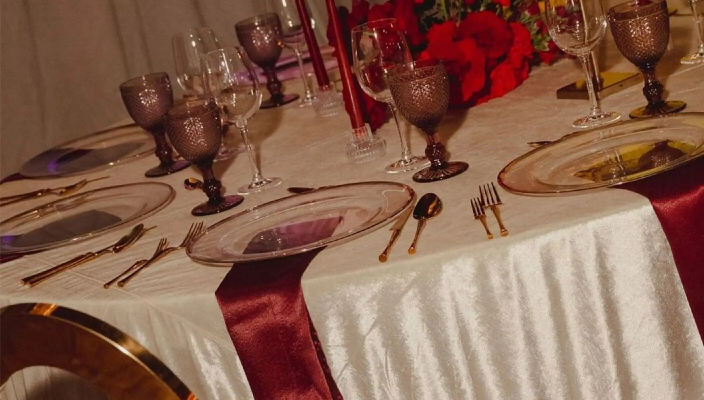 Indoor wedding reception table with red roses and velvet linens at Devossion by Live Aqua, Playa Del Carmen