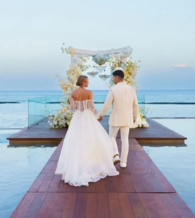 The couple walking towards an floral altar at Devossion by Live Aqua, Playa Del Carmen
