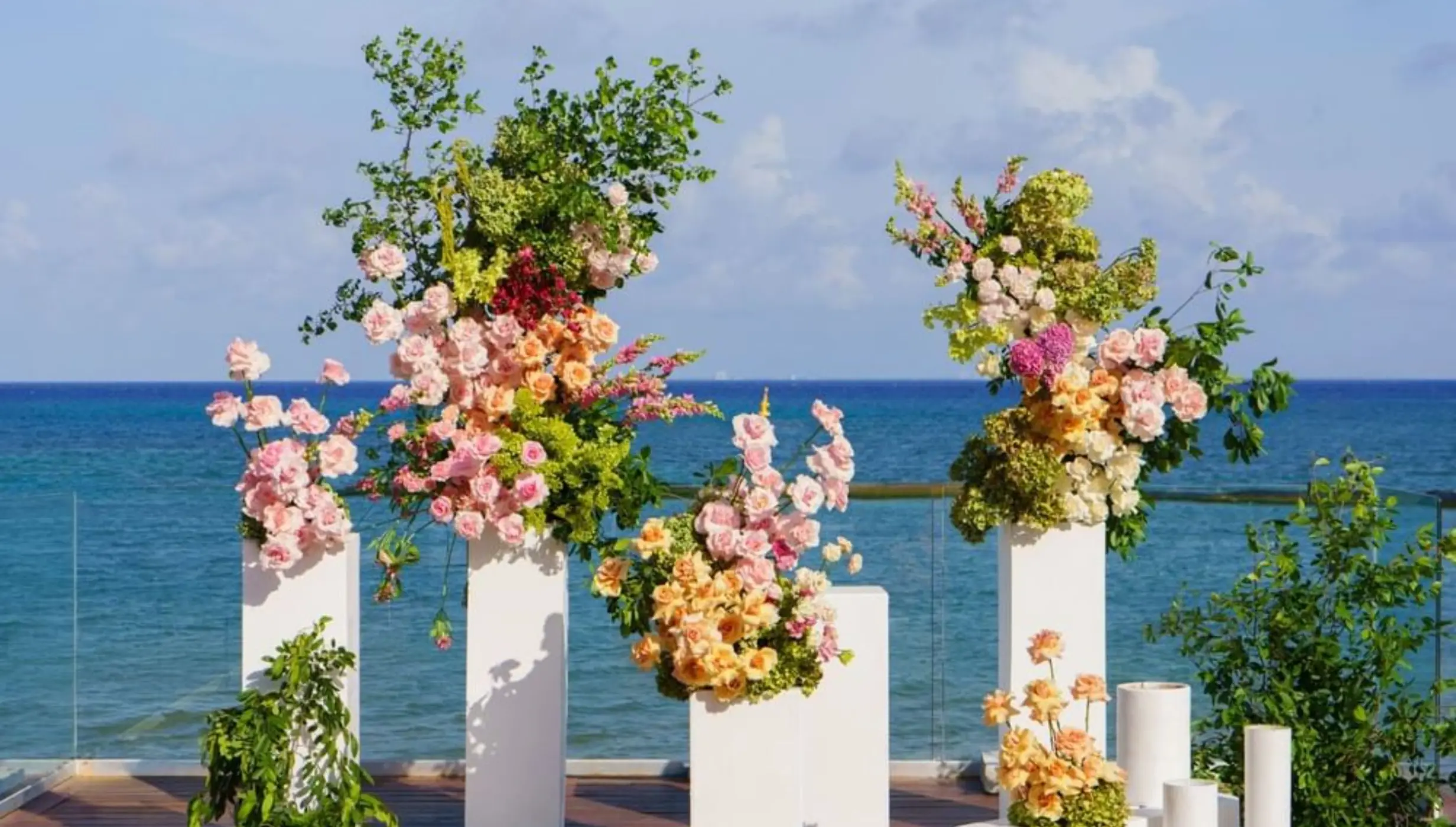 Floral pillars for a wedding ceremony at Devossion by Live Aqua, Playa Del Carmen