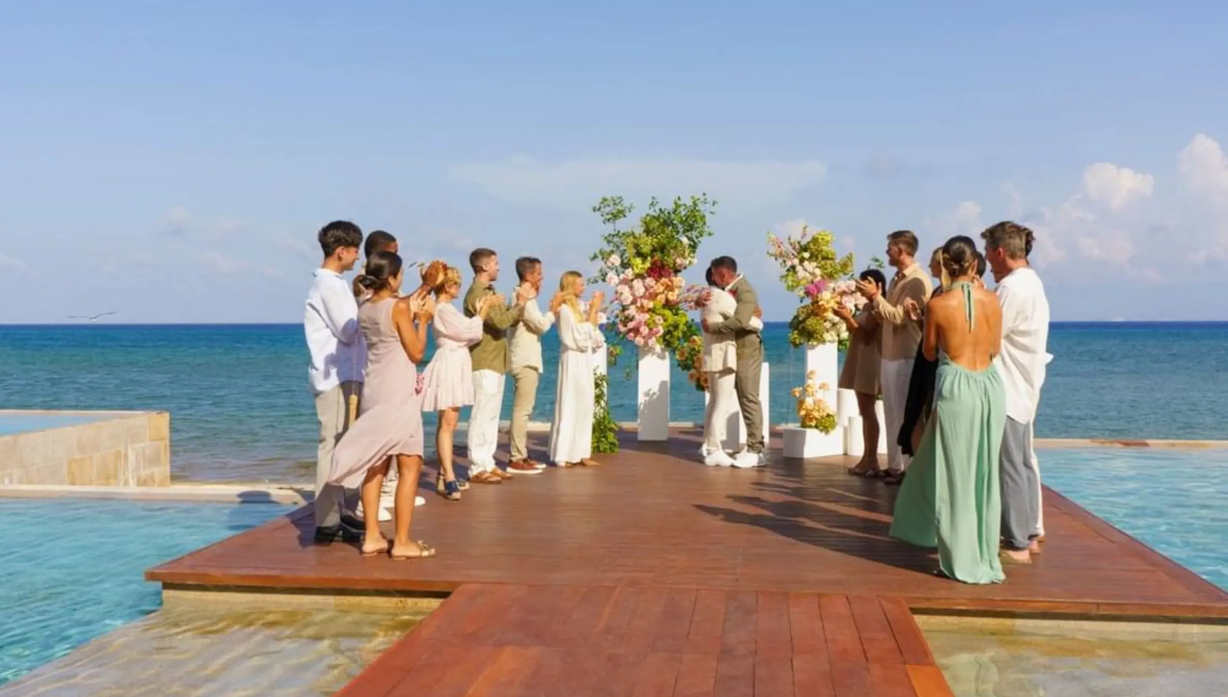 Wedding ceremony on a wooden deck overlooking the ocean at Live Aqua Playa del Carmen
