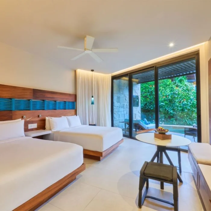 suite with two beds at Devossion by Live Aqua Playa del Carmen