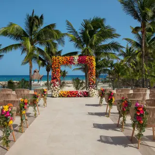 Colorful floral square arch for a terrace wedding ceremony at Dreams Aventuras, Riviera Maya