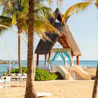 Oceanfront wedding ceremony gazebo and beach reception setup at Dreams Aventuras, Riviera Maya
