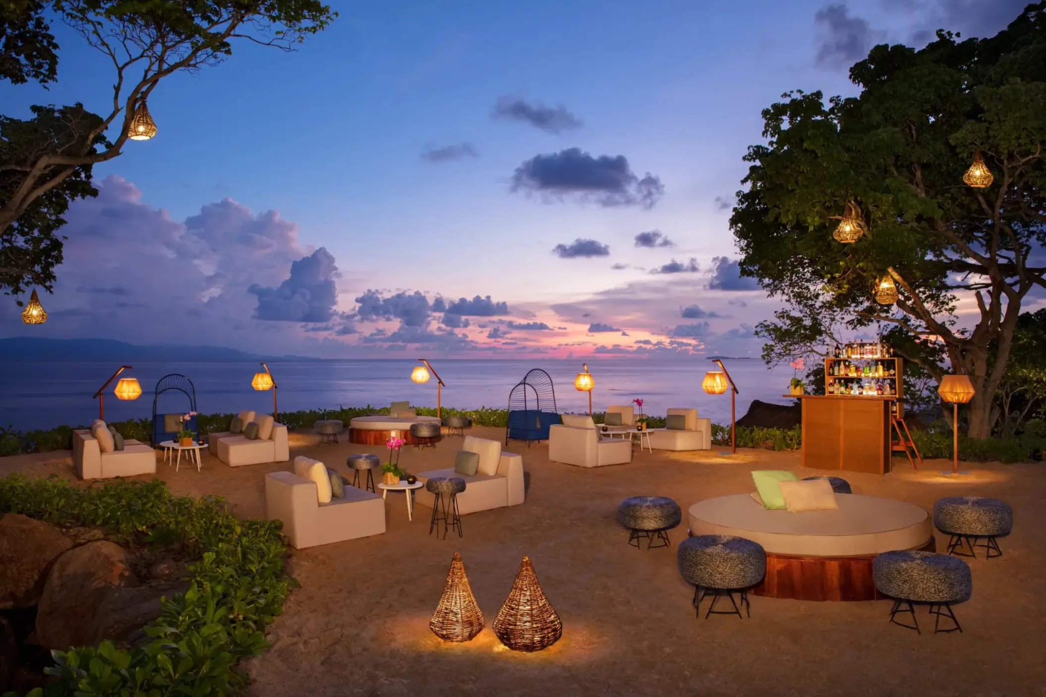 Evening wedding reception lounge with lanterns and ocean views at Dreams Bahia Mita, Puerto Vallarta