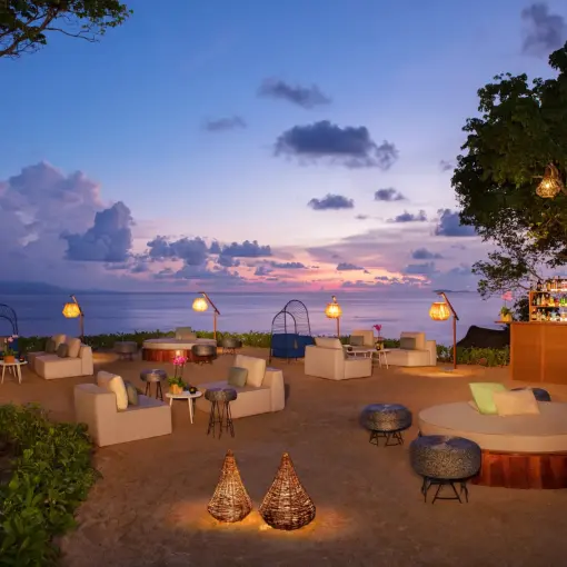 Evening wedding reception lounge with lanterns and ocean views at Dreams Bahia Mita, Puerto Vallarta