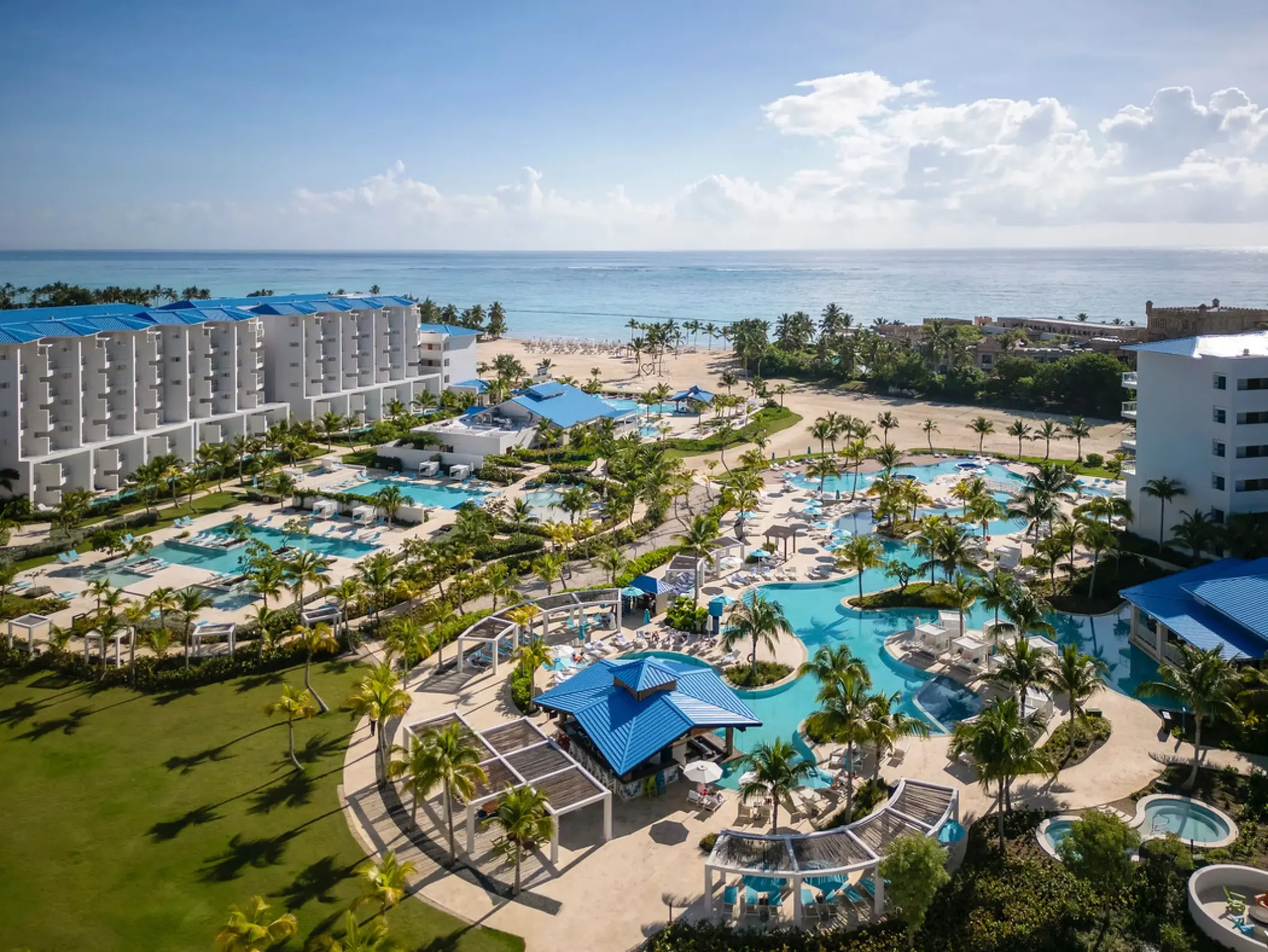 Aerial view of Dreams Cap Cana resort pools and white-sand beach, Punta Cana