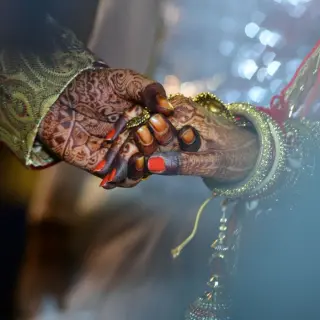 Close-up of an Indian bride and groom holding hands for a wedding ceremony at Dreams Cap Cana, Punta Cana