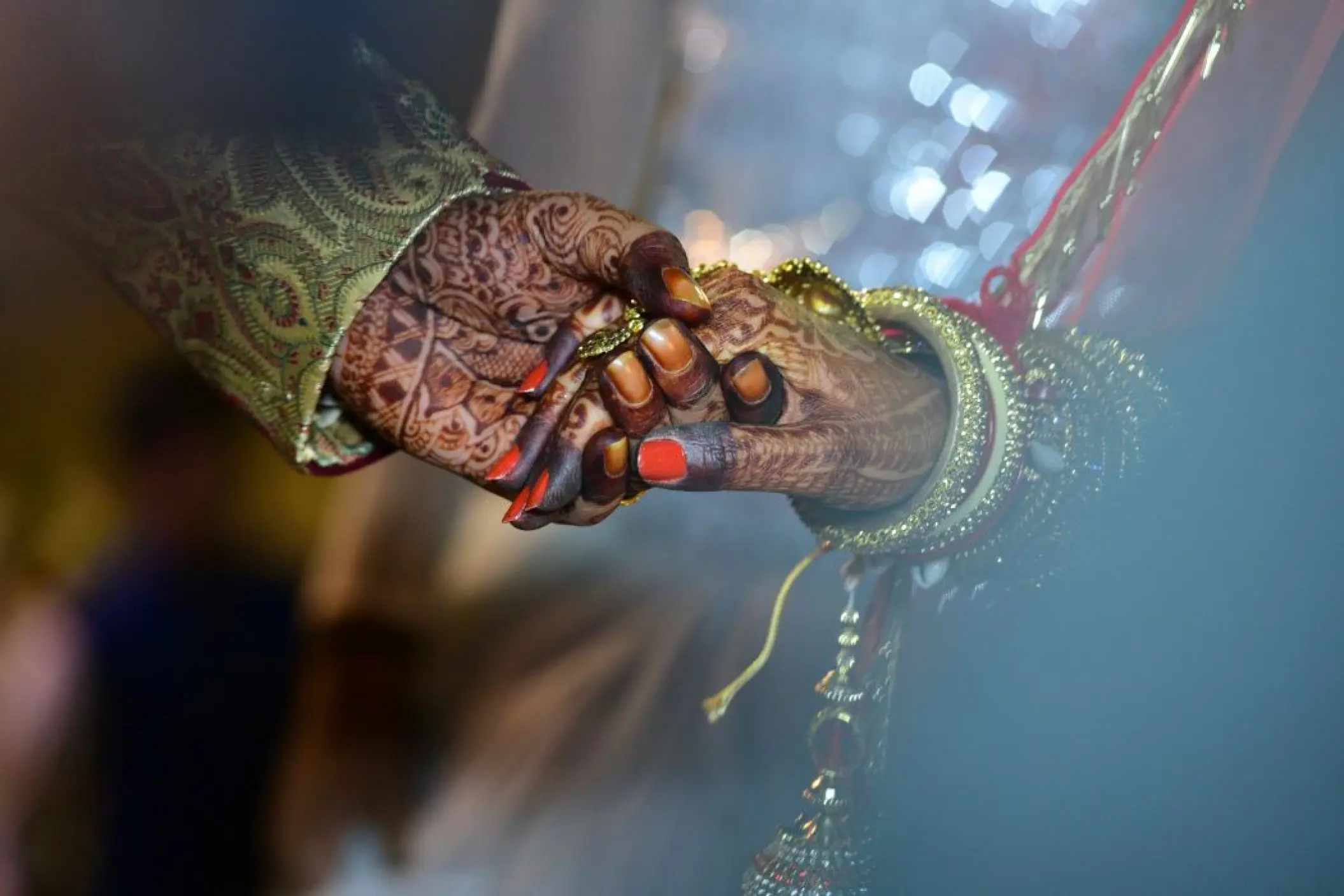Close-up of an Indian bride and groom holding hands for a wedding ceremony at Dreams Cap Cana, Punta Cana