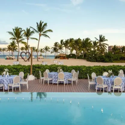 Outdoor wedding reception setup on the pool deck at Dreams Cap Cana, Punta Cana