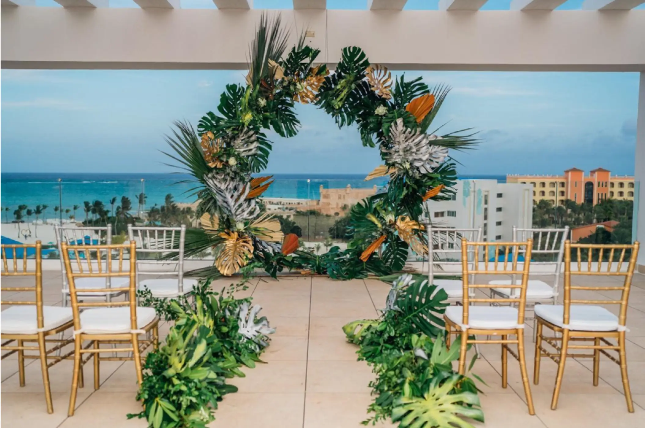 Sky deck wedding ceremony with a tropical leaf arch at Dreams Cap Cana, Punta Cana