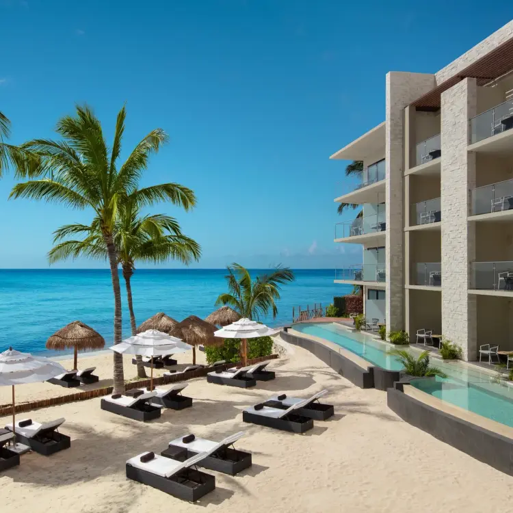 Dreams Cozumel Cape beachfront swim-out suites and lounge chairs on the beach, Cozumel