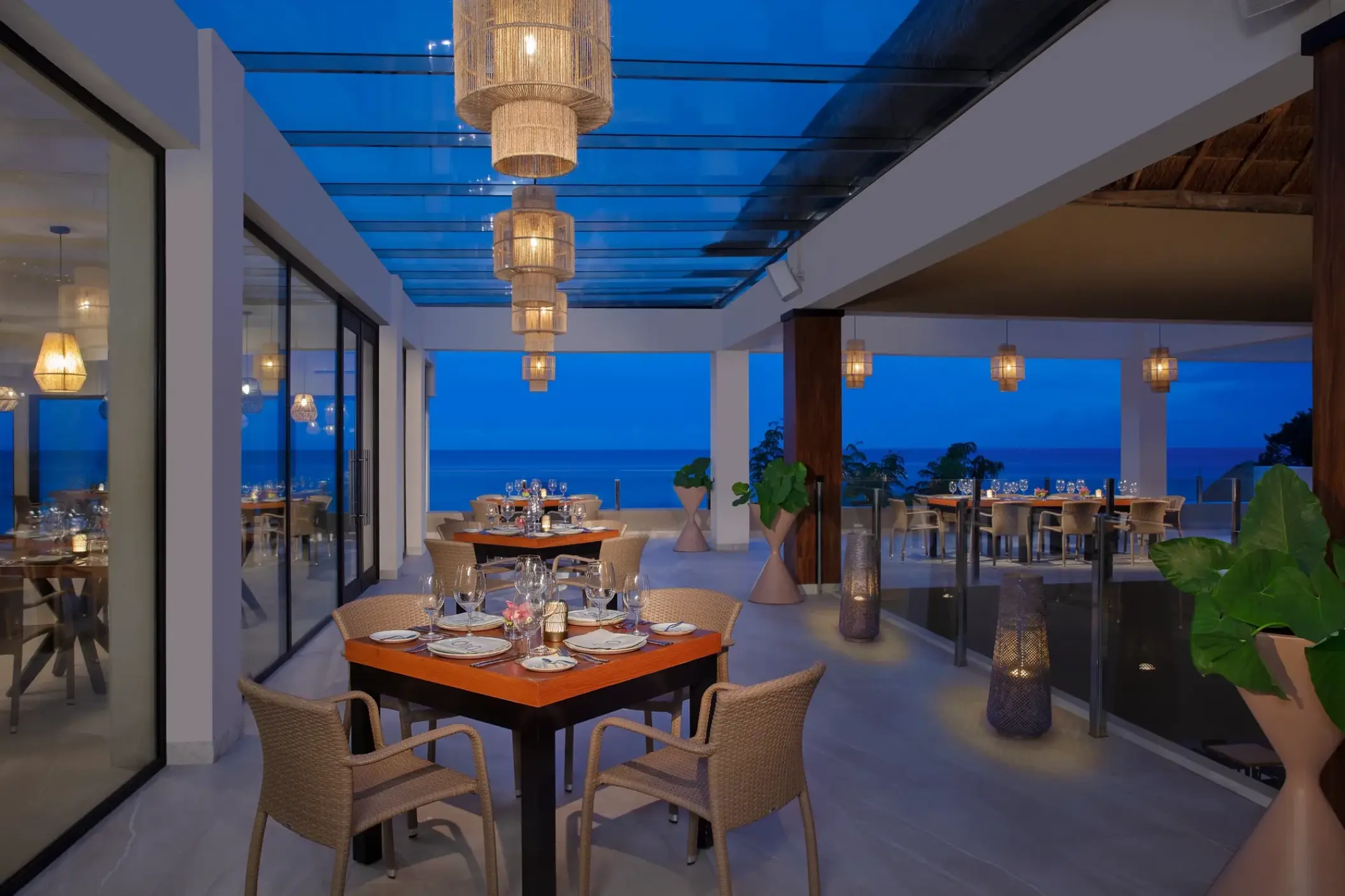 Olio terrace restaurant at Dreams Cozumel Cape under a glass roof with ocean views, Cozumel