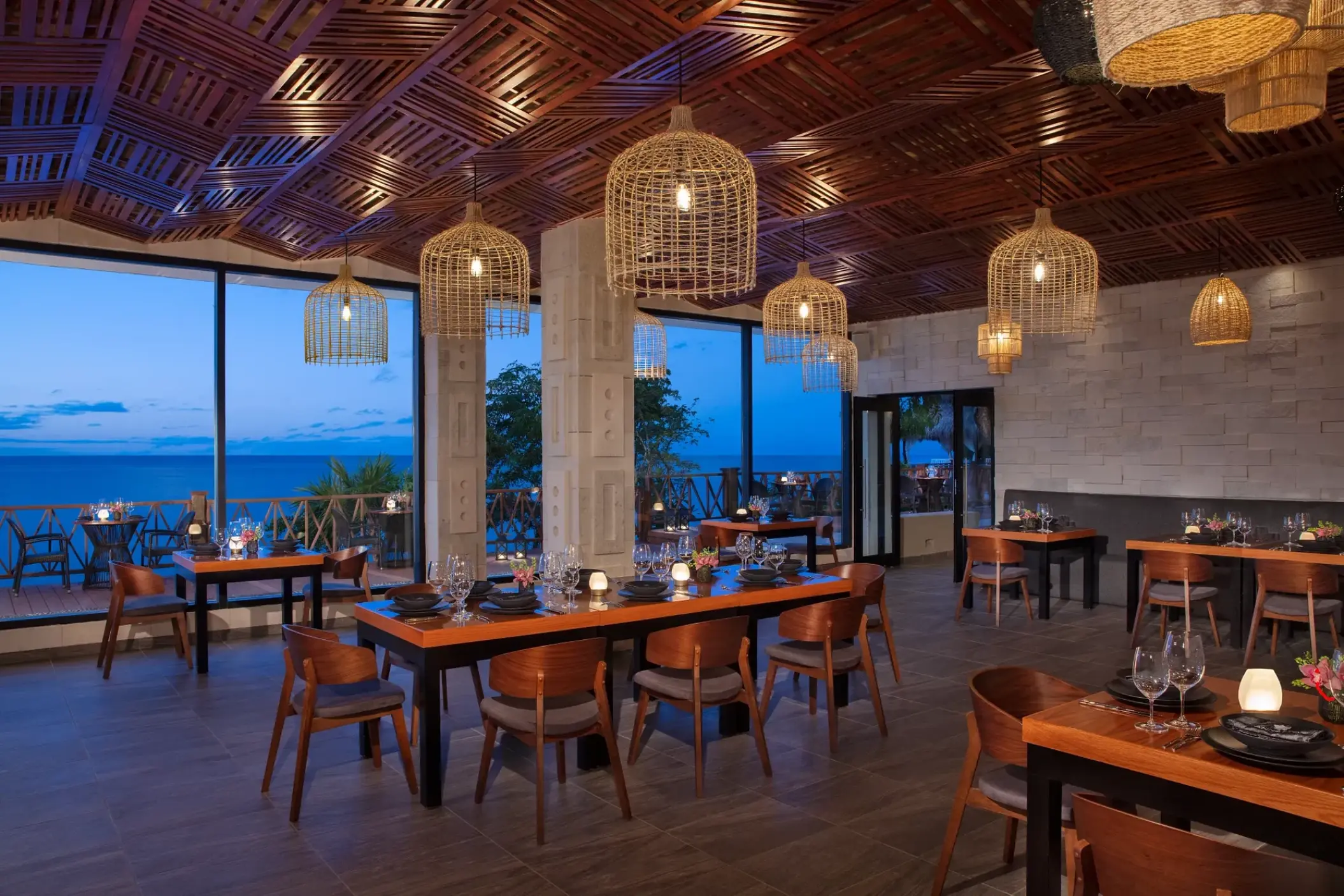 Annatto restaurant with birdcage lanterns and ocean views at Dreams Cozumel Cape, Cozumel