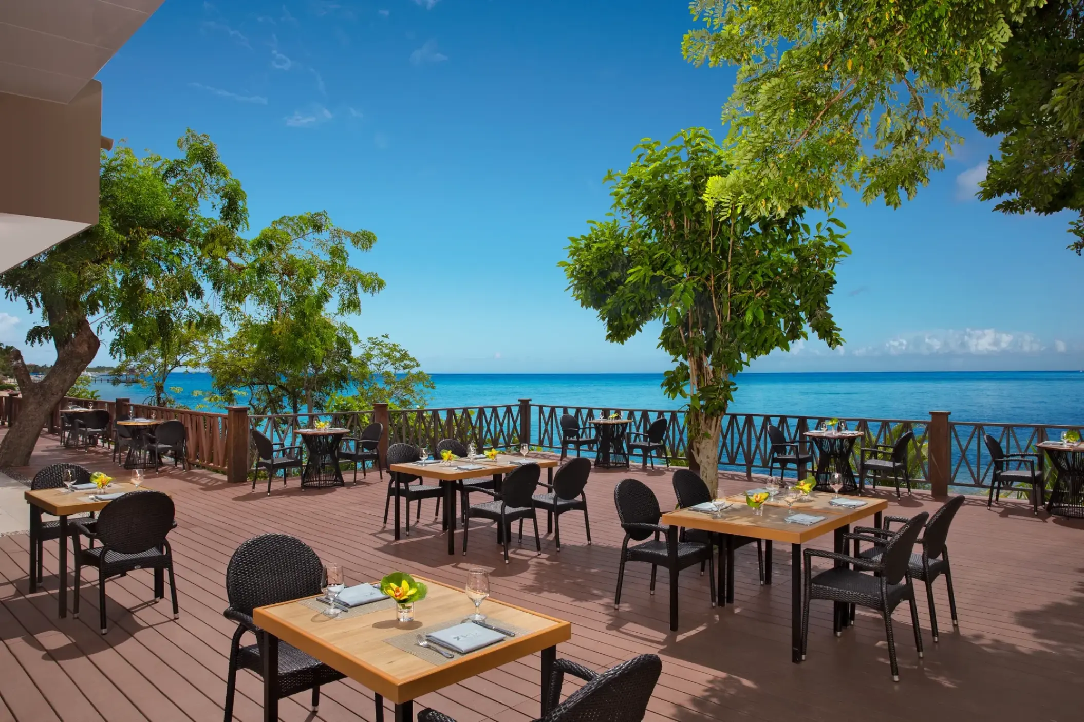 Outdoor terrace dining at Dreams Cozumel Cape overlooking the turquoise ocean, Cozumel