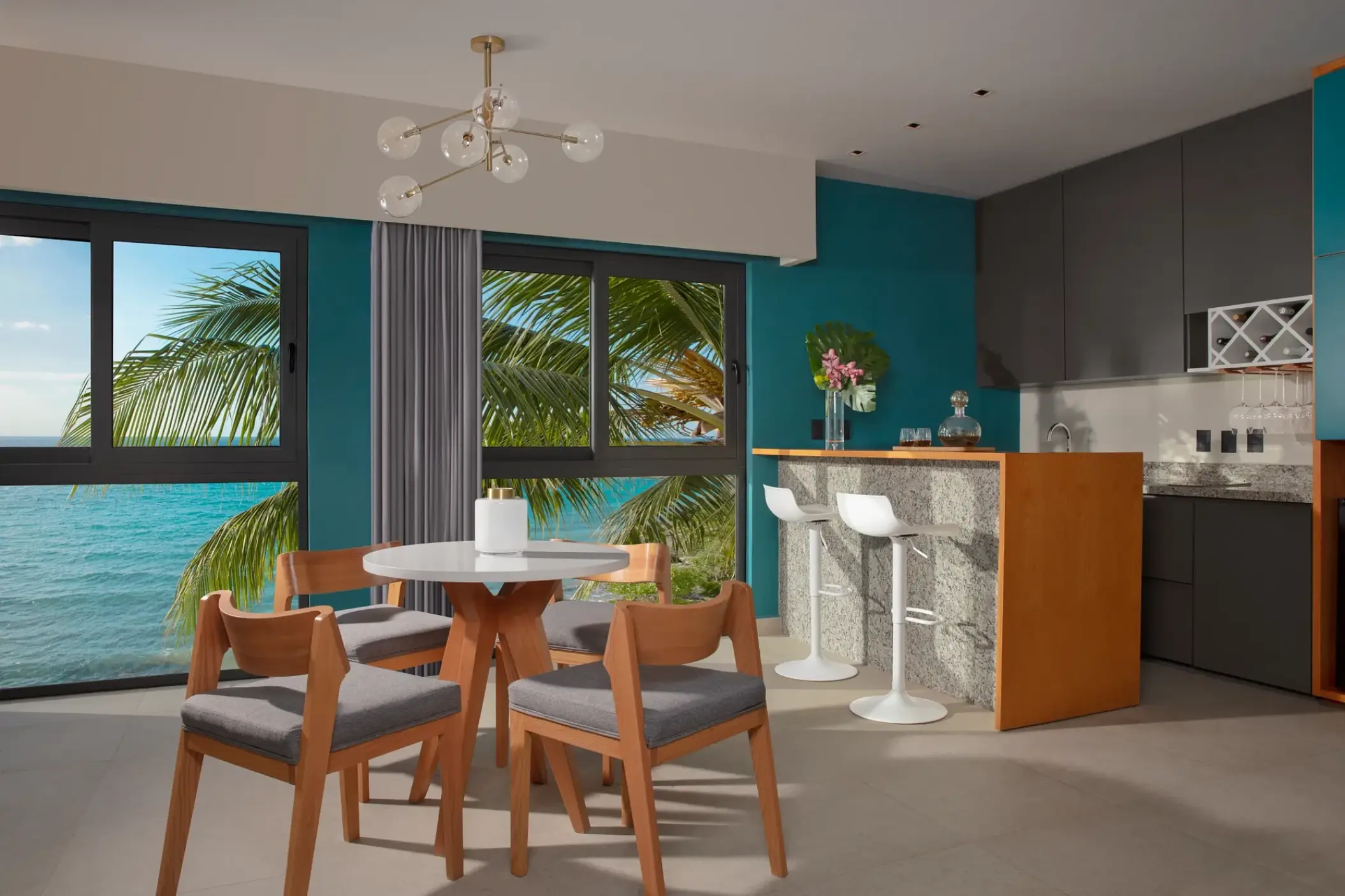 Master suite ocean view living area with a dining table and breakfast bar at Dreams Cozumel, Cozumel
