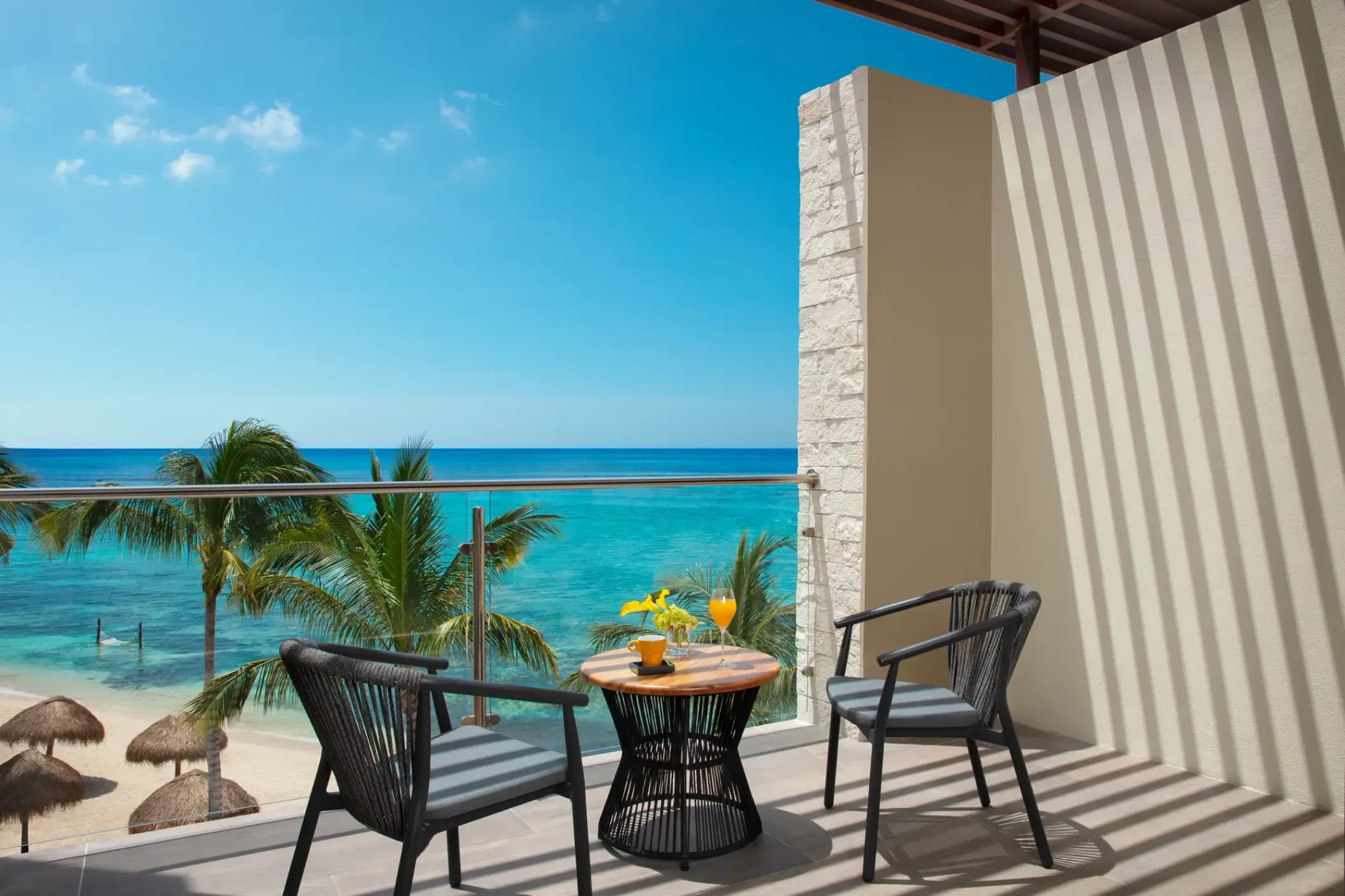 Private oceanfront suite balcony with seating at Dreams Cozumel, Cozumel