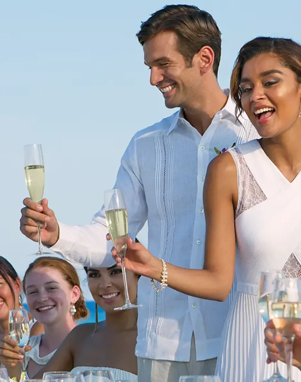 The couple and wedding guests raising a champagne toast at Dreams Cozumel Cape, Cozumel