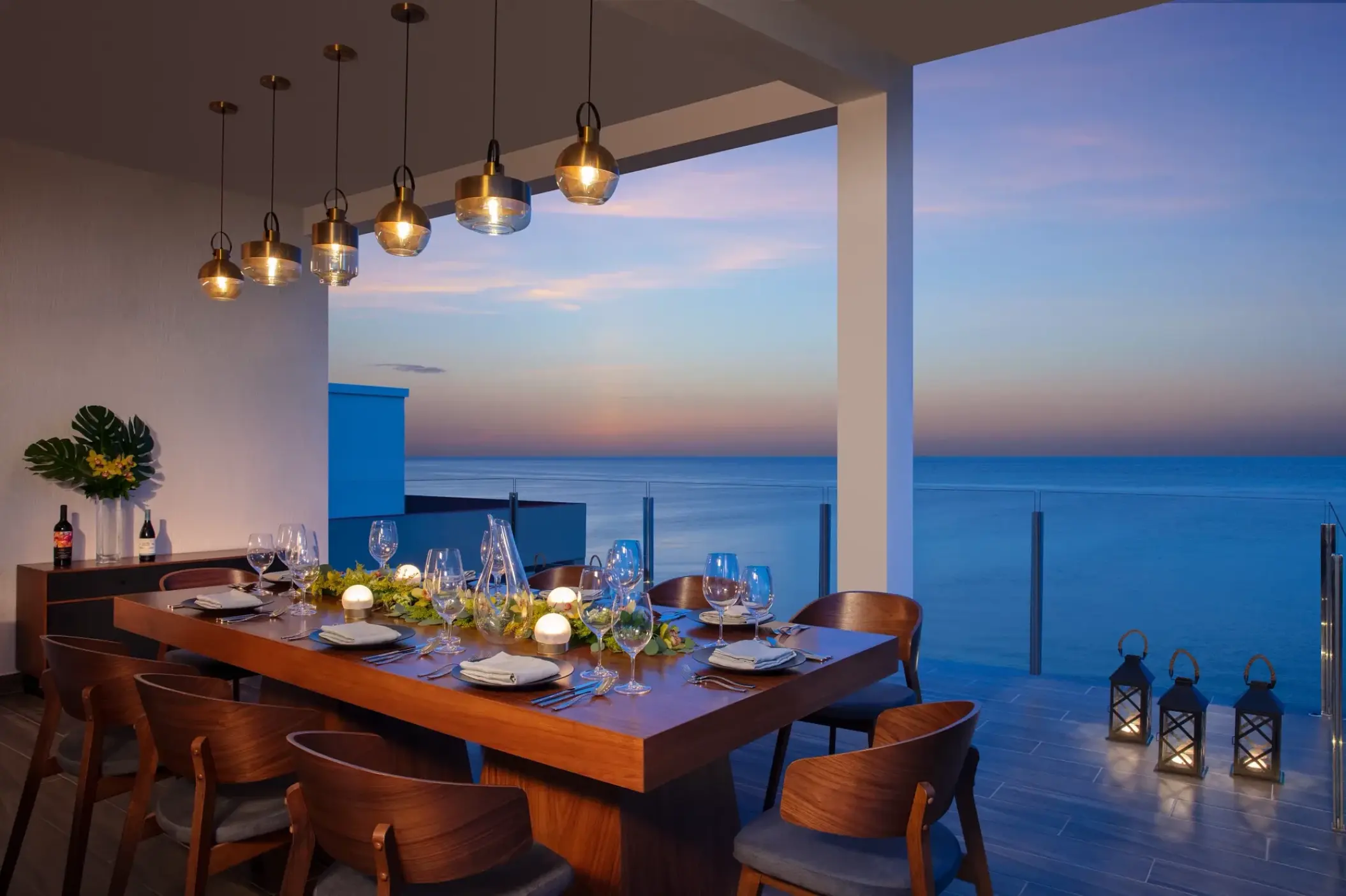 Rooftop terrace wedding reception at Dreams Cozumel overlooking the ocean at sunset, Cozumel