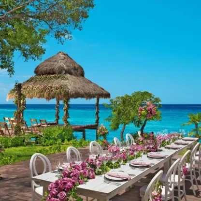 Terrace wedding reception with floral runners at Dreams Cozumel Cape, Cozumel